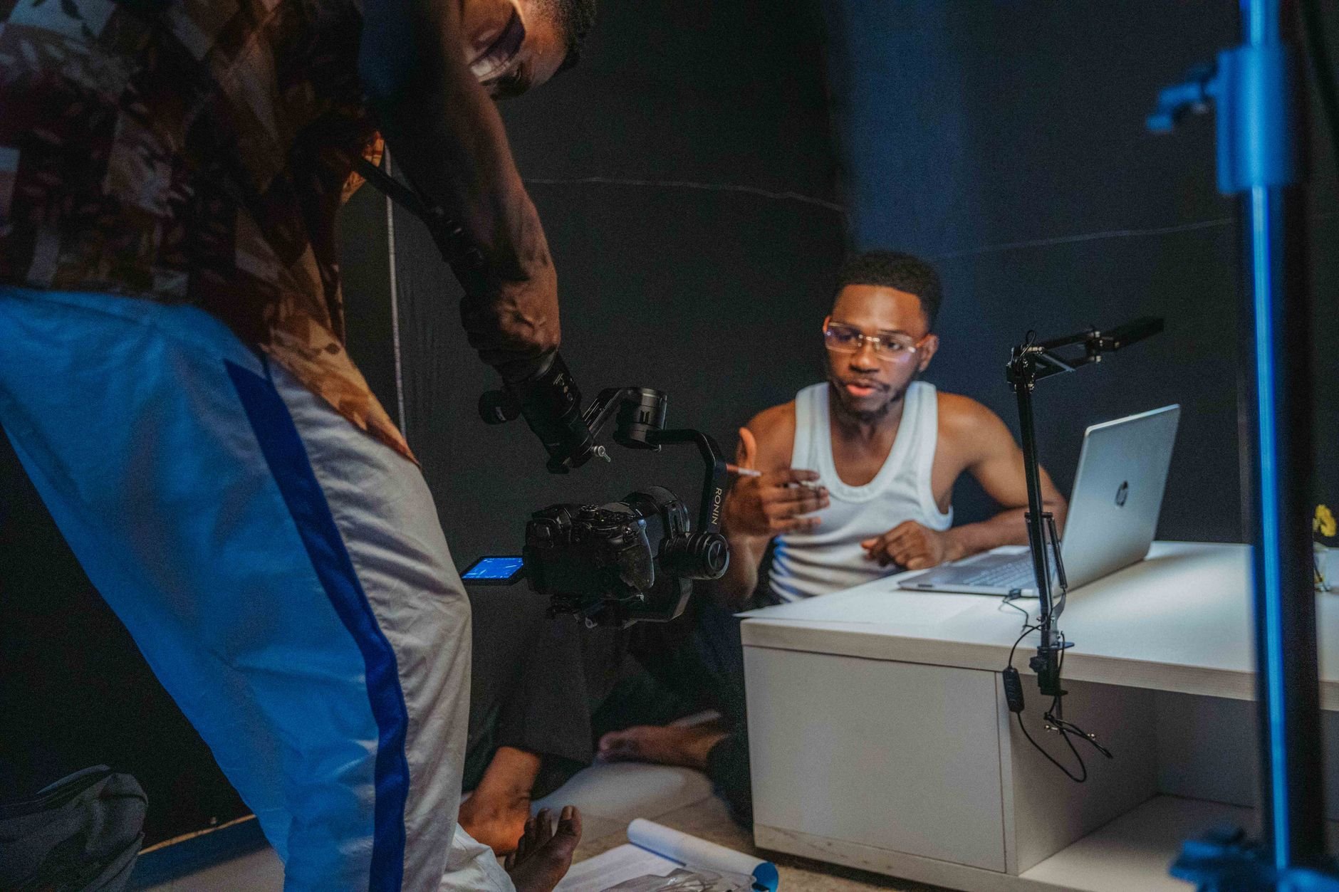 Young creators filming a casual video with laptop and camera in a home studio